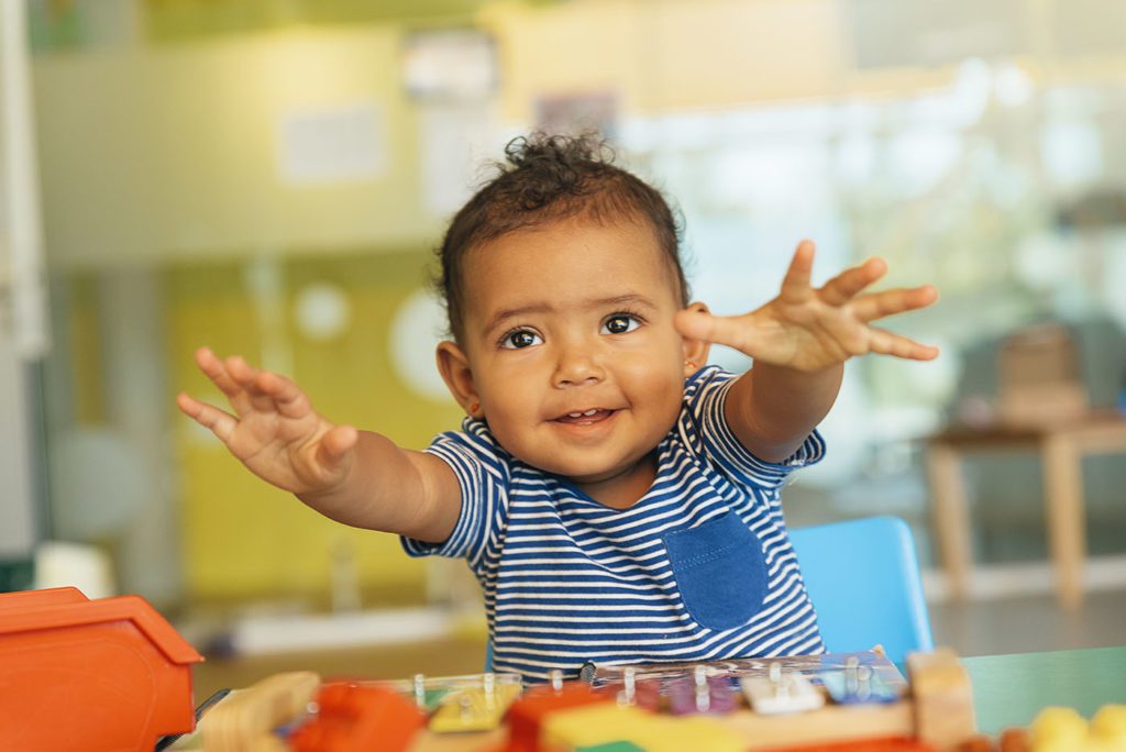 Happy baby playing with toy blocks at a Preschool & Daycare Serving San Antonio, TX