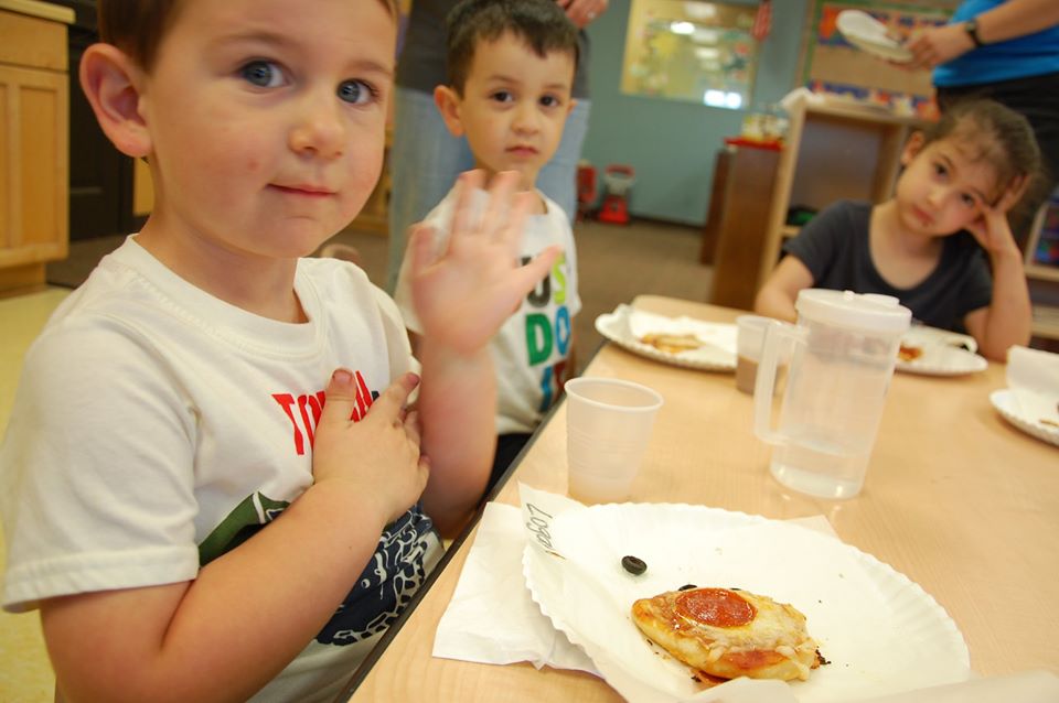 children sitting at a table eating food at a Preschool & Daycare Serving San Antonio, TX