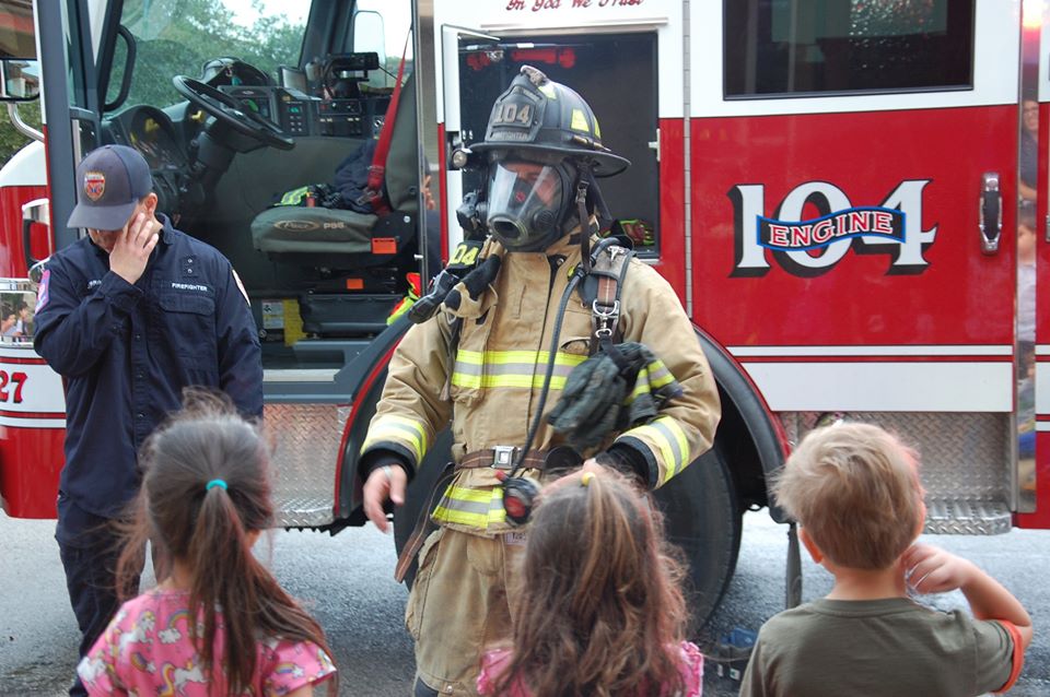 firefighters and children outside at a Preschool & Daycare Serving San Antonio, TX