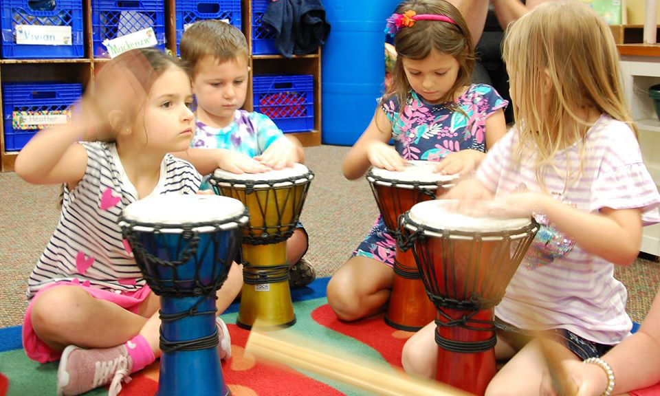 girls playing drums at a Preschool & Daycare Serving San Antonio, TX
