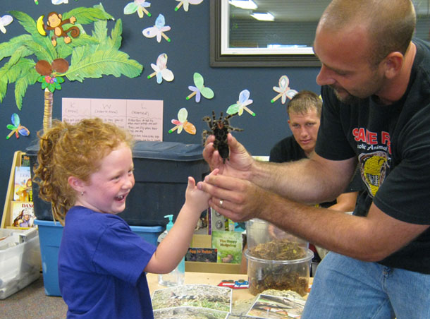 happy girl playing with spider at a Preschool & Daycare Serving San Antonio, TX