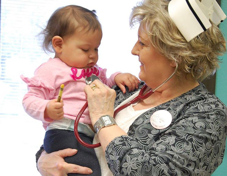 nurse holding baby at a Preschool & Daycare Serving San Antonio, TX