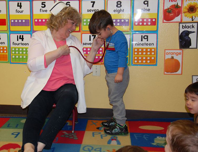 nurse playing with toddler at a Preschool & Daycare Serving San Antonio, TX