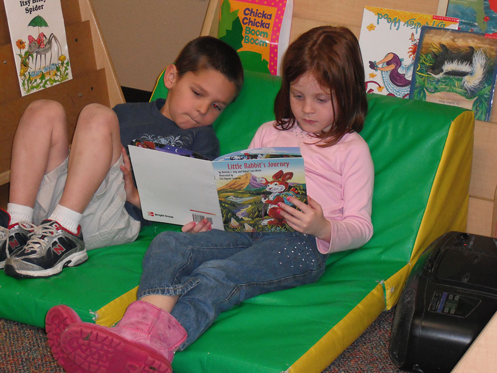 preschool boy & girl reading book at a Preschool & Daycare Serving San Antonio, TX