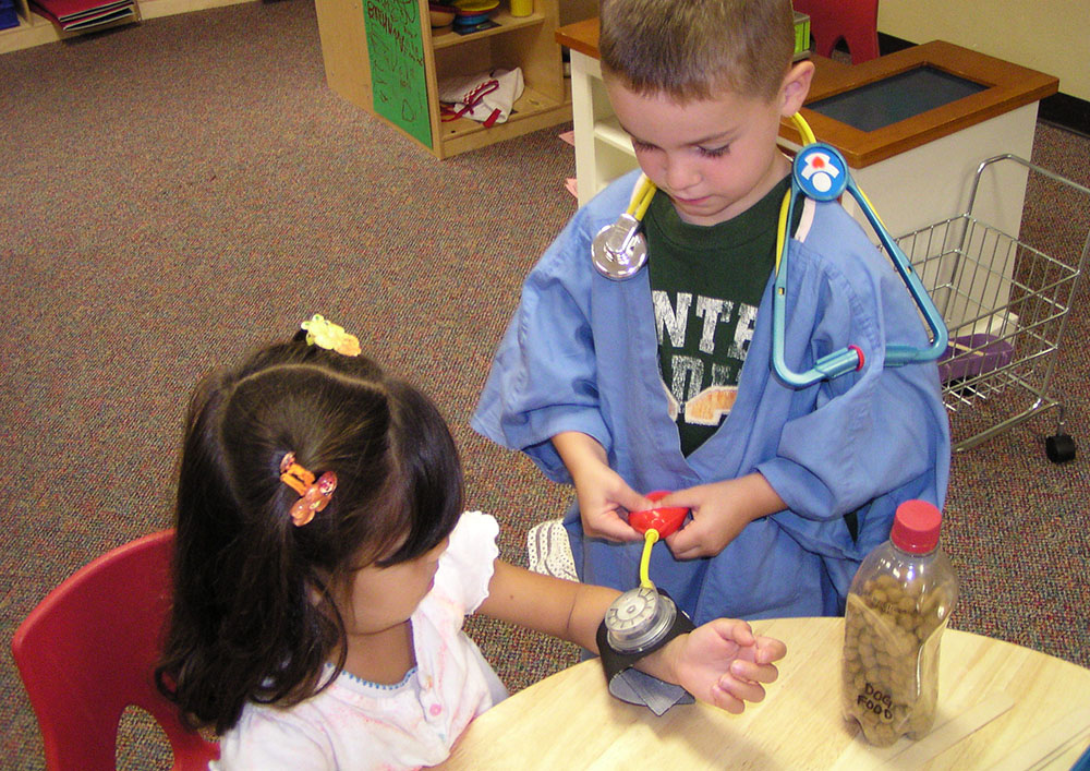 preschool boy playing with classmate at a Preschool & Daycare Serving San Antonio, TX