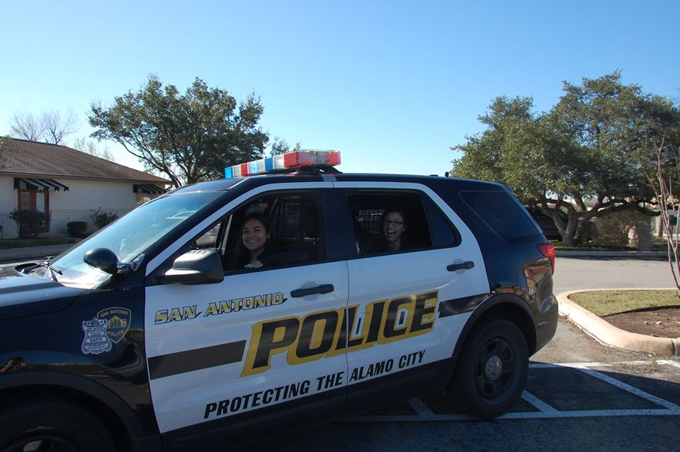 smiling teachers inside police car at a Preschool & Daycare Serving San Antonio, TX