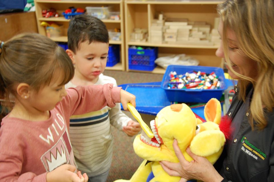teacher showing preschool children oral health at a Preschool & Daycare Serving San Antonio, TX