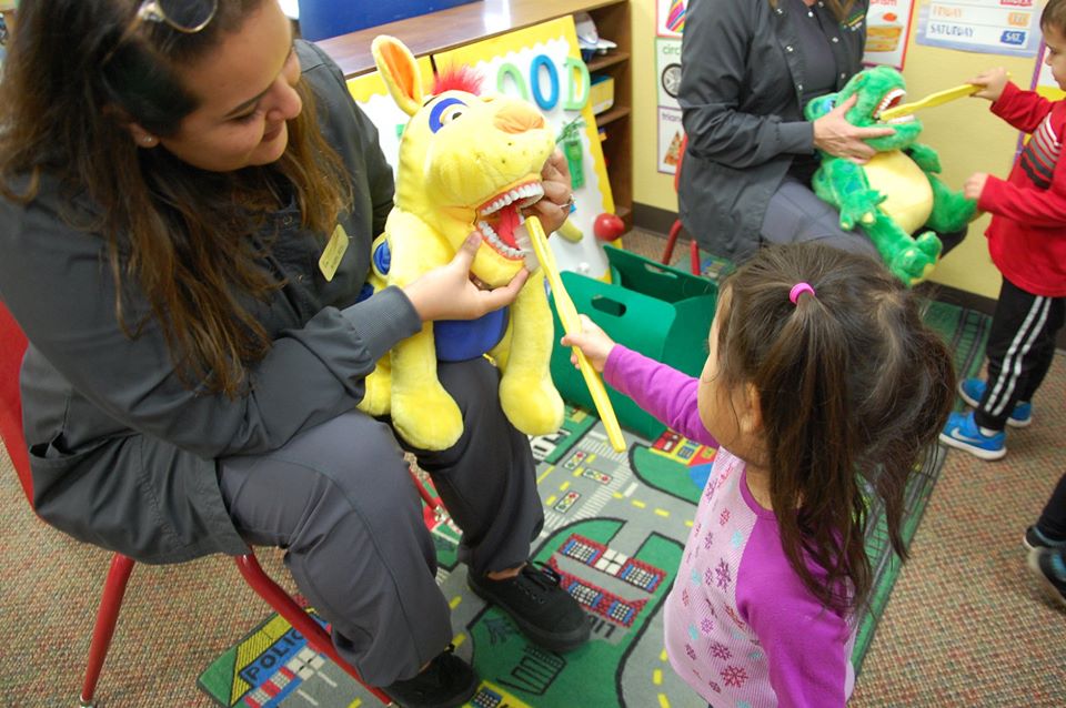 teacher teaching oral health at a Preschool & Daycare Serving San Antonio, TX