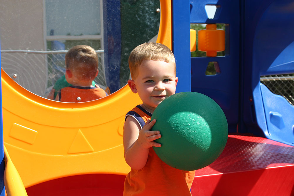 toddler boy playing with ball at a Preschool & Daycare Serving San Antonio, TX