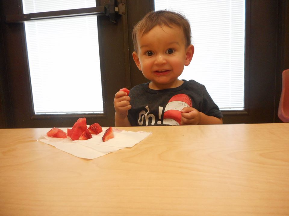 toddler eating strawberries at a Preschool & Daycare Serving San Antonio, TX